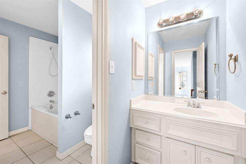 Luxurious master bathroom featuring a spacious vanity, elegant lighting, and a relaxing bathtub for your comfort.
