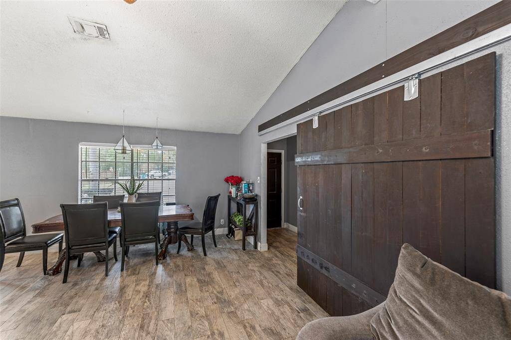 Dining area with sliding barn door seperates the living area from the bedrooms.