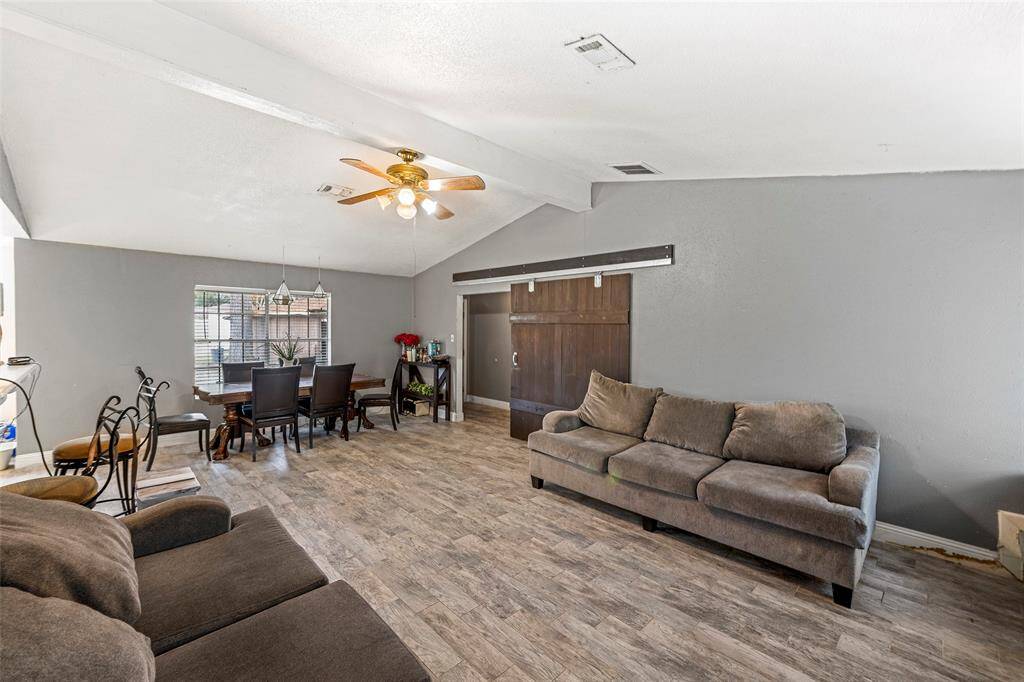 Living/Dining combo features a barn door that provides privacy from the bedrooms.