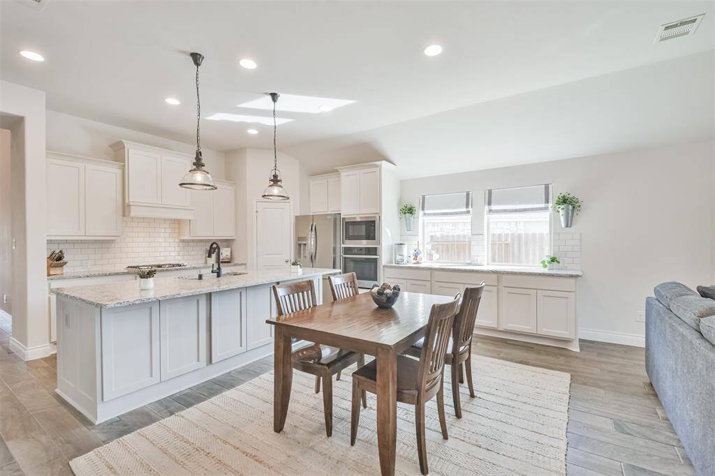 Dining room is highlighted by LED lighting and a buffet of cabinets with added storage and serving space.