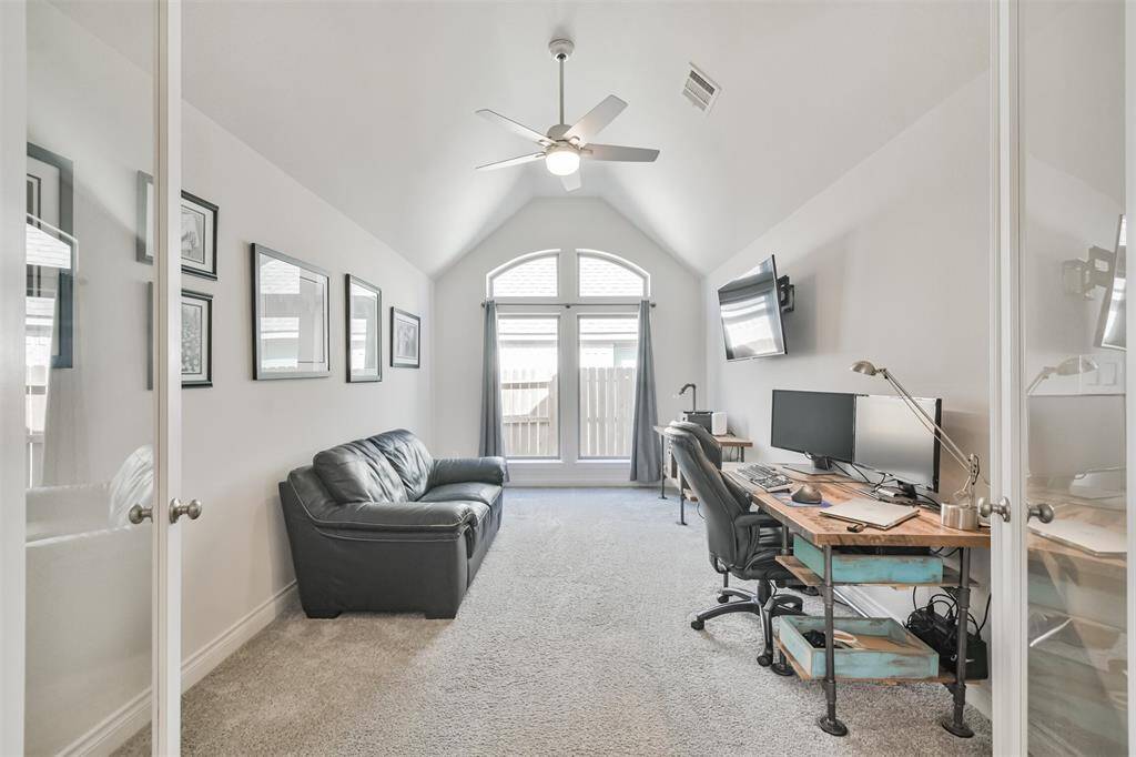 French doors lead to vaulted gameroom/study with high windows for natural light.