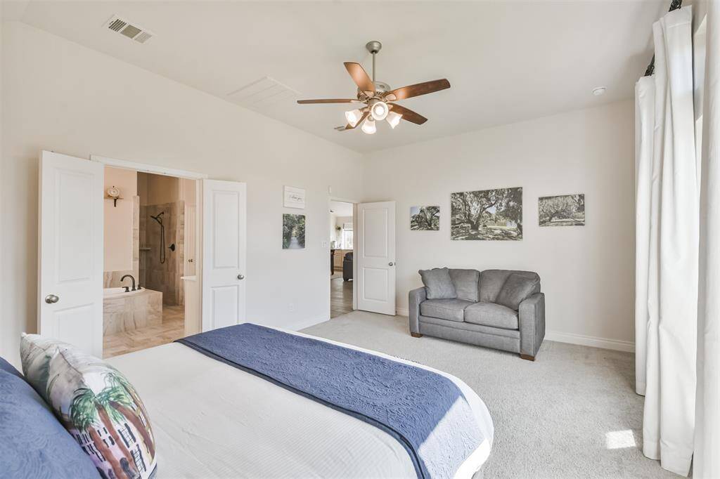 Primary bedroom opens to a luxurious bath.