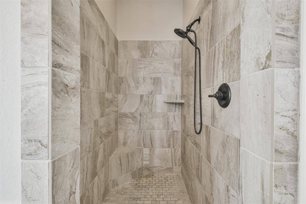 Mudset super shower has seat, shelf, and upgraded fixtures.