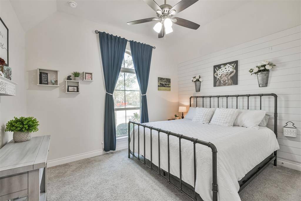 Front bedroom with shiplap accent wall is large enough for a king size bed.