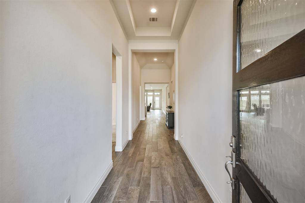 Enter the home to appreciate trayed ceilings and wood look tile that flows throughout the main living areas of the home.