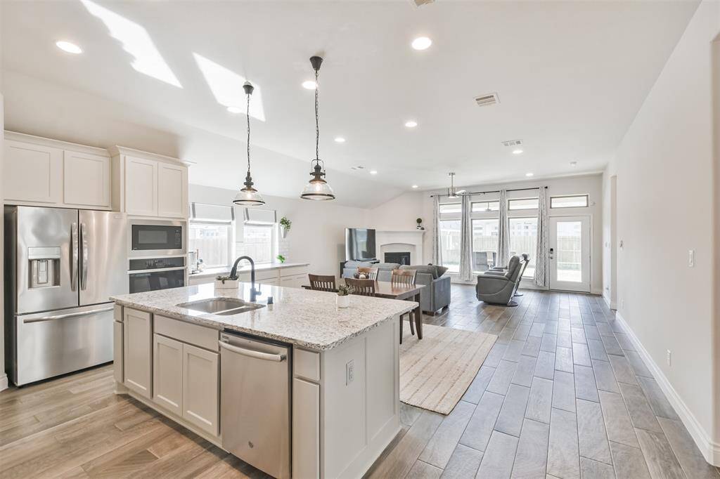 The main living areas, kitchen, dining, and living, flow together to create a truly great space, filled with natural light.