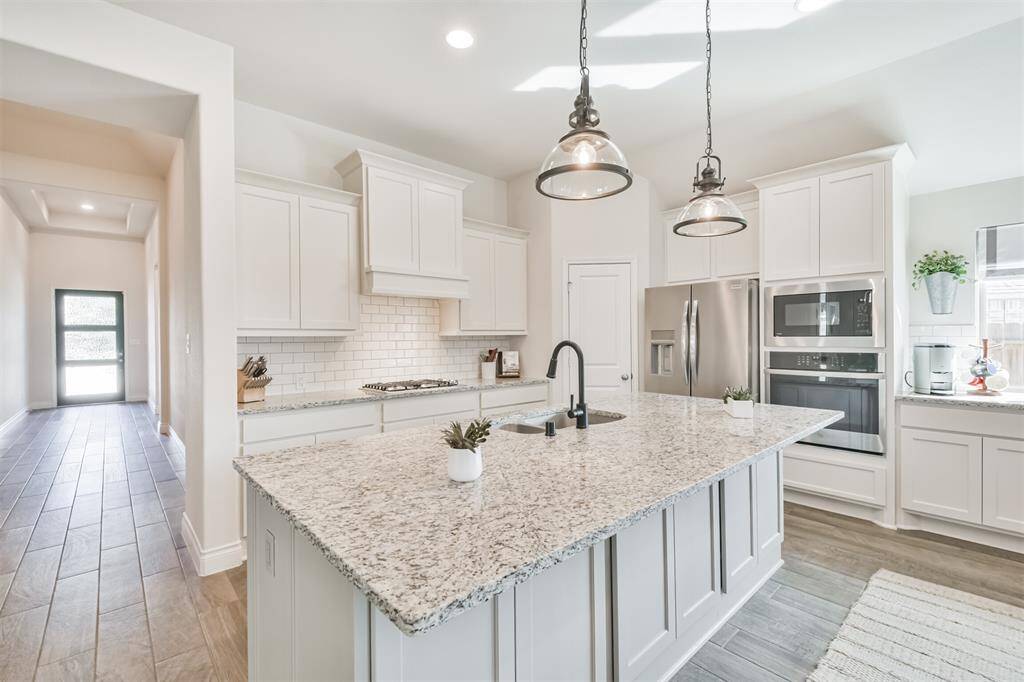 Cabinets open up under breakfast bar for more storage.