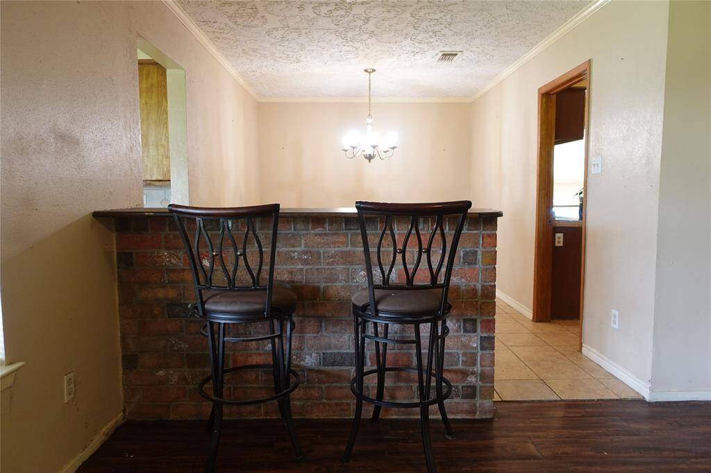 Cozy bar area adjacent to the formal dining room, offering a seamless flow into the living space. Perfect for entertaining.