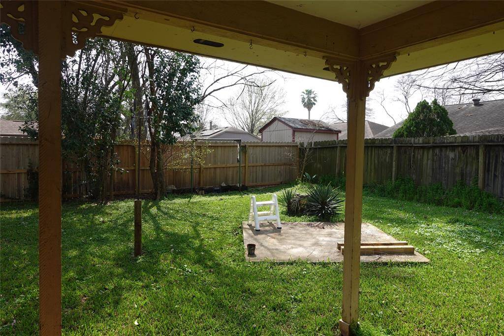 Enjoy a serene view of the spacious backyard and covered patio right from your kitchen.