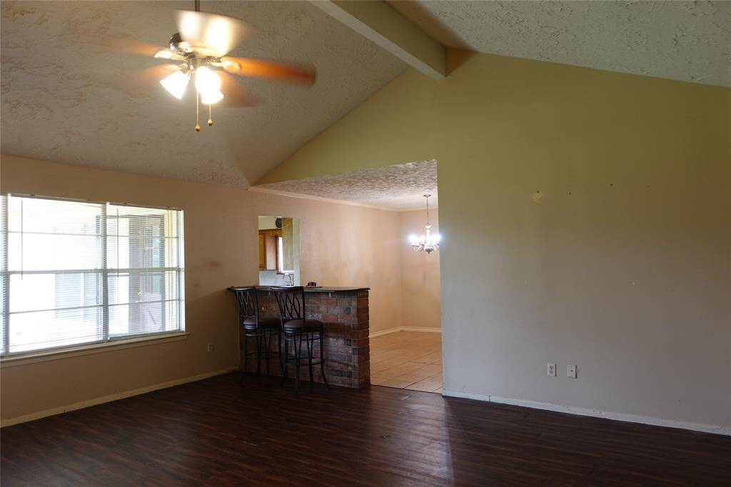 Spacious living area with a cozy bar and elegant formal dining space, perfect for entertaining.