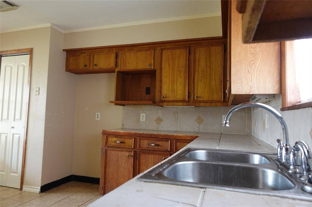 Charming kitchen with ample cabinet space, a dual sink, and natural light perfect for any home chef.