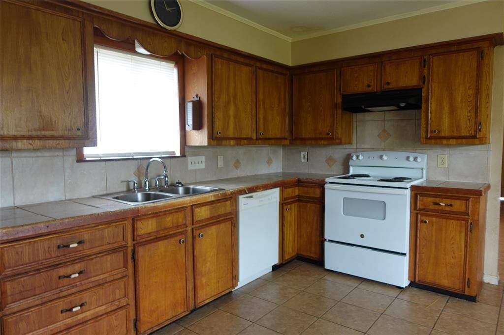 Spacious kitchen with ample cabinet storage.