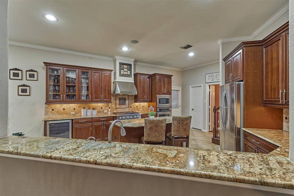 Gorgeous kitchen that opens to the breakfast and living areas.  Also connected to the formal living.  Seating at both the central island and the raised counter between the kitchen and living room.