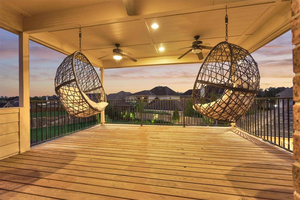 Upstairs covered balcony with complete views of the backyard.