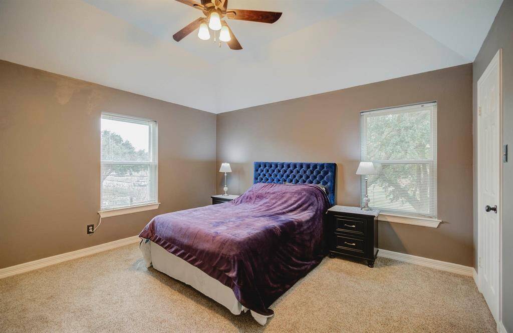 Cozy second bedroom with ample natural light and a serene view.
