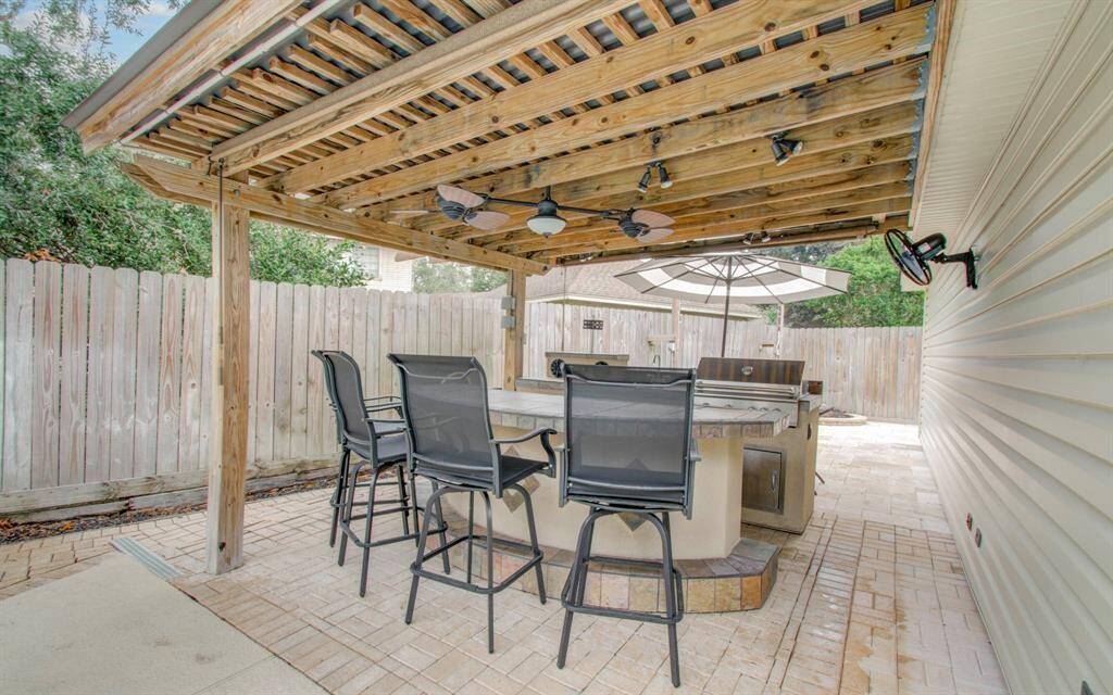 Experience outdoor dining at its finest with this stunning kitchen setup.