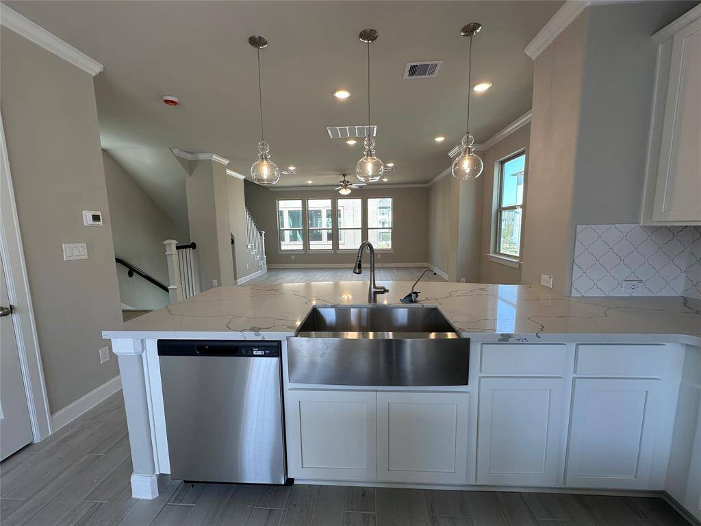 Kitchen overlooks dining area and great room