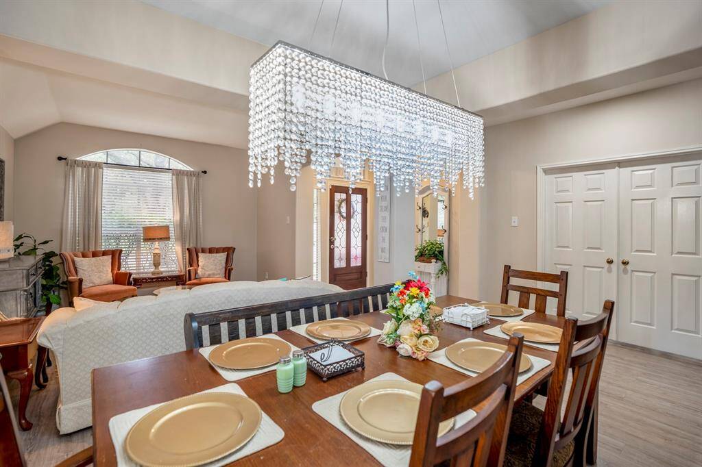 Another angle of the formal dining area, offering a clear view of the front door to the left near the formal living room and the double doors leading to the home office across the entry hallway. This layout enhances the home's flow and functionality.