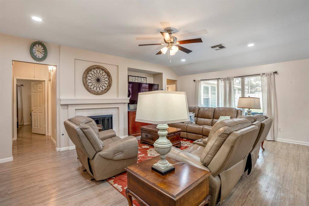Moving toward the rear of the home, the family room welcomes you with its open and inviting layout. To the left, a hallway leads to the laundry room, one of the secondary bedrooms, and the secondary bath, offering convenient access to essential spaces.
