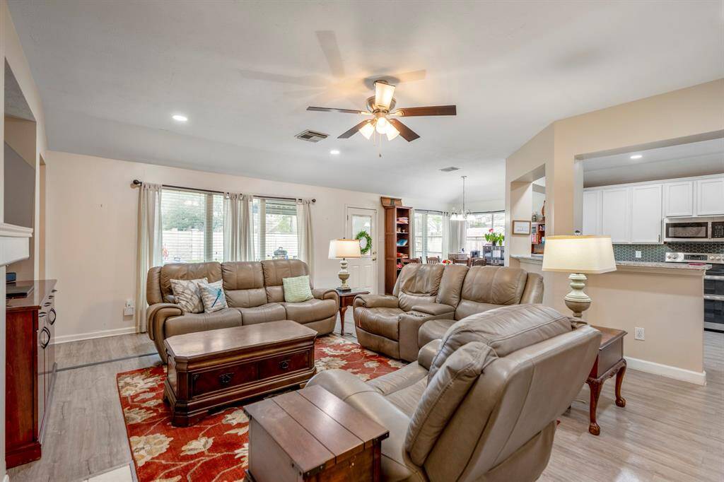 Standing near the hallway to the secondary bedroom, the open layout between the family room, breakfast area, and kitchen creates a spacious and inviting atmosphere, perfect for gatherings and entertaining.