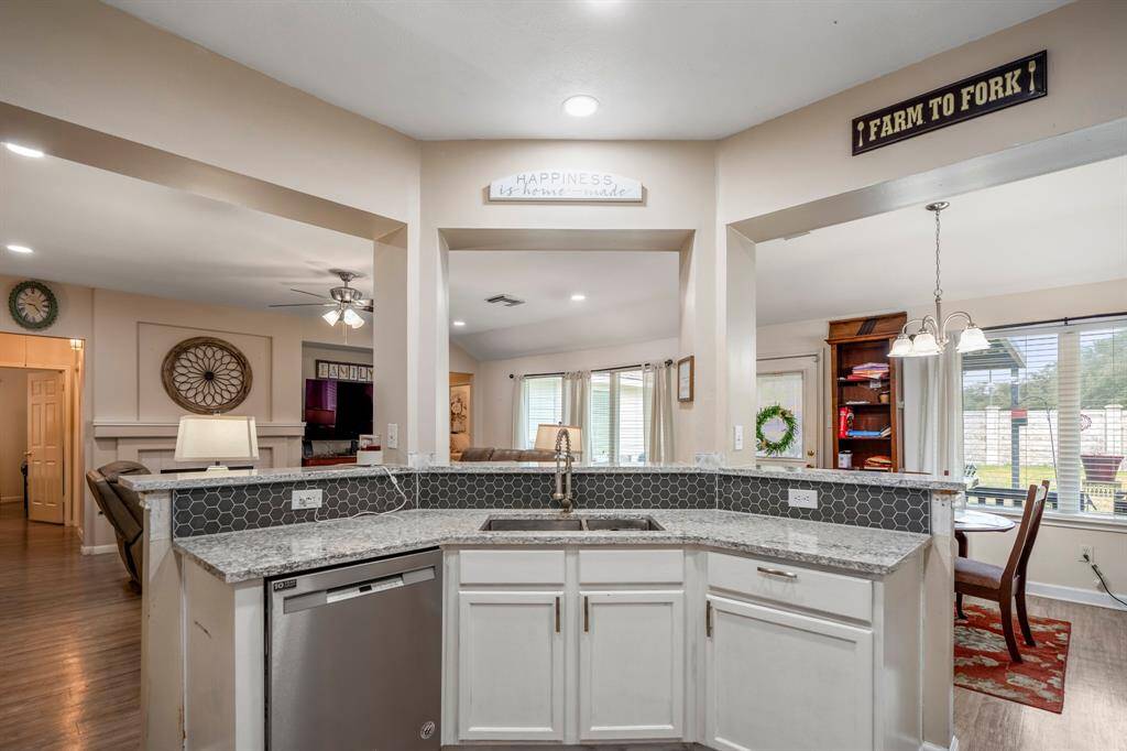 Standing inside the kitchen, looking out across the island, you'll appreciate the raised breakfast bar that creates a perfect spot for casual dining or entertaining while maintaining an open flow into the family room and breakfast area.