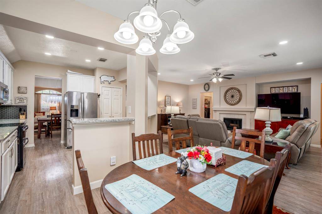 Moving back into the breakfast space, you get a full view of the open layout between the kitchen, family room, and breakfast area, creating a seamless flow for easy entertaining. Through the kitchen doorway, you can see the formal dining and living areas, further enhancing the home's spacious feel.