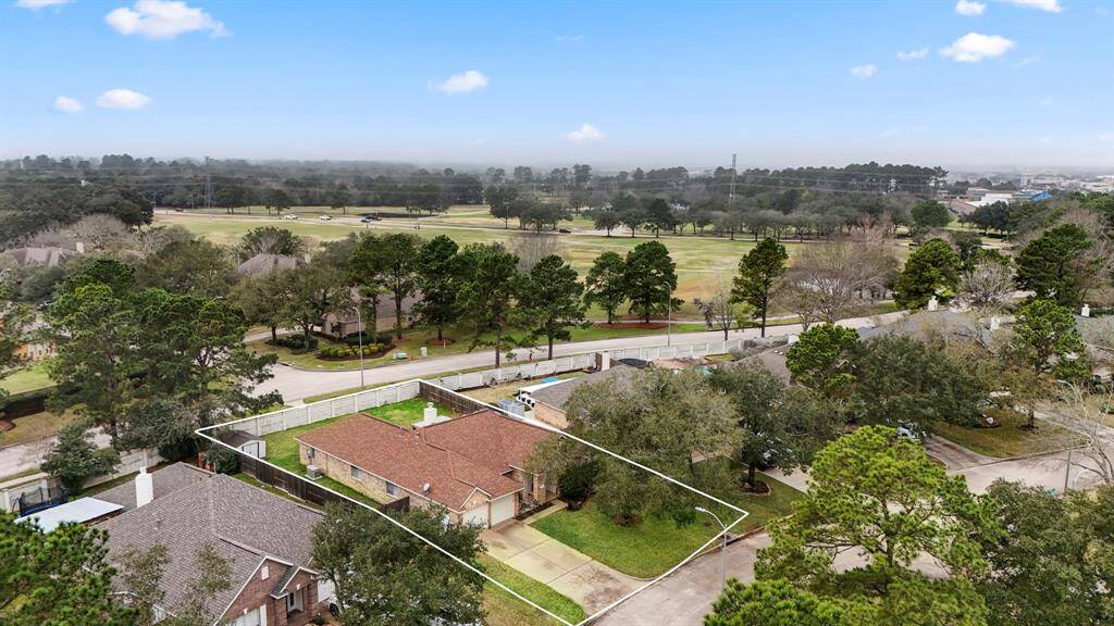 An aerial view highlighting the serene privacy of no rear neighbors, with the Windrose Golf Course in the distance. This prime location in Windrose offers the perfect balance of tranquility and convenience, with easy access to community amenities and nearby major roads.