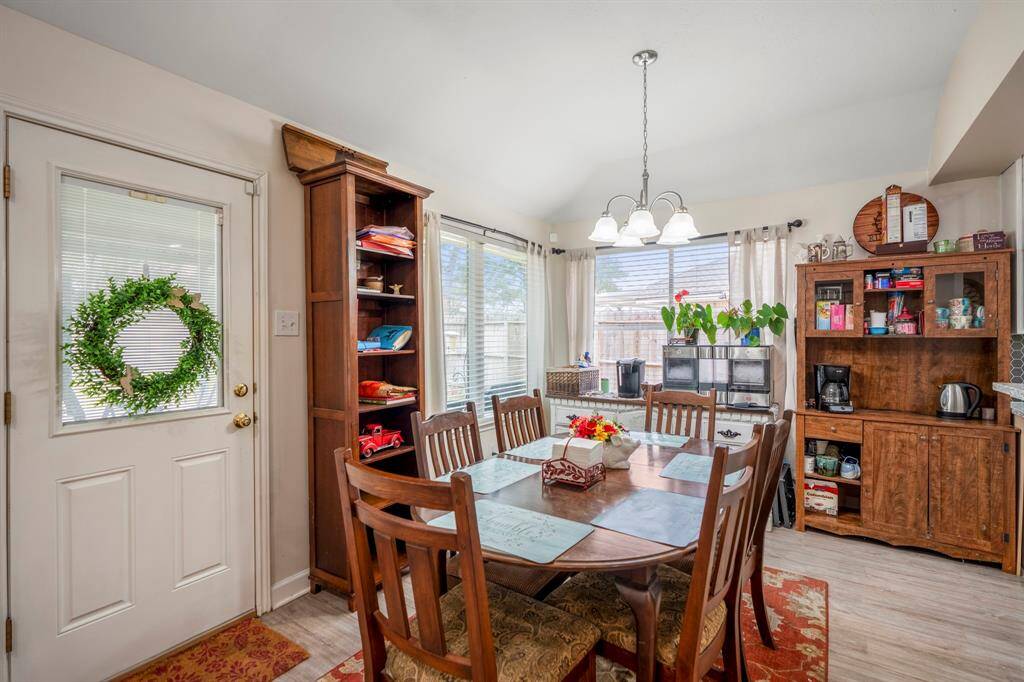 A great look at the bright and inviting breakfast area, featuring large windows that fill the space with natural light and offer a pleasant view of the outdoors.
