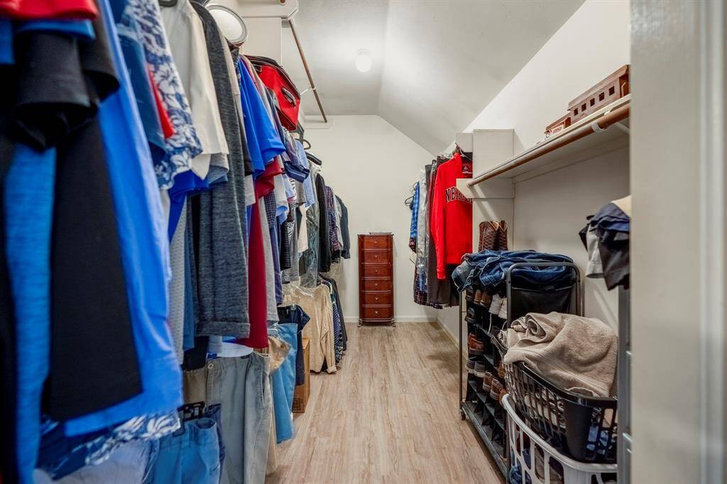 A peek inside the primary closet reveals a surprisingly spacious area, offering plenty of room for all your wardrobe needs—truly a standout feature of this home!