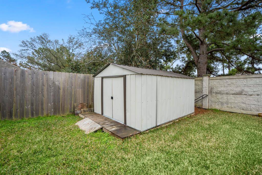 A storage shed in the backyard, providing extra space for tools, equipment, or outdoor storage, helping to keep your outdoor area organized and clutter-free.