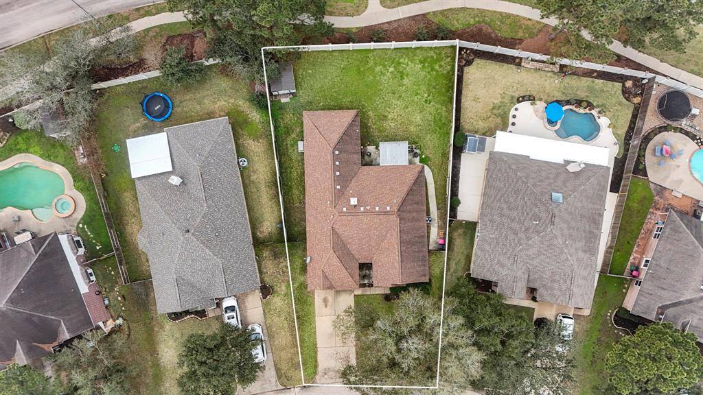 Another overhead aerial view, highlighting the generous backyard space with no rear neighbors, offering a serene and private environment. The covered patio adds to the outdoor appeal, ideal for enjoying the tranquil surroundings.