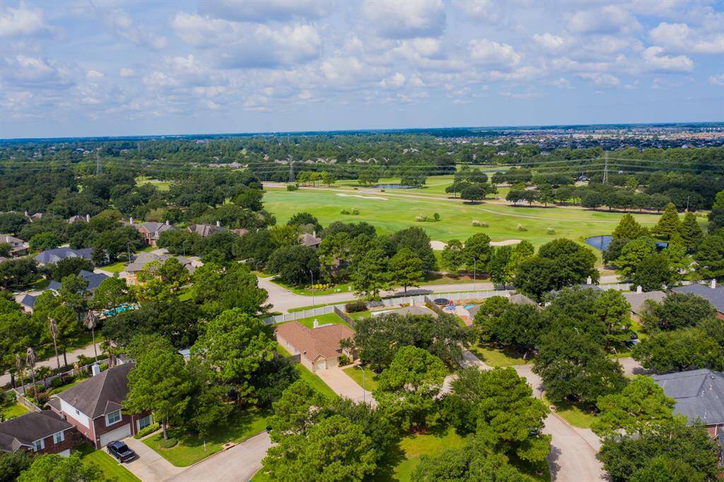 An aerial view showing the home's prime location with no rear neighbors, offering privacy and a scenic view of the Windrose Golf Course beyond, creating a peaceful and picturesque setting.