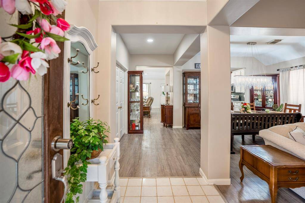 Step inside to a spacious layout with the formal living and dining areas to your right, perfect for entertaining. Straight ahead, the family room welcomes you with an open and airy feel. To the left, double doors lead to a private home office, offering a quiet retreat.
