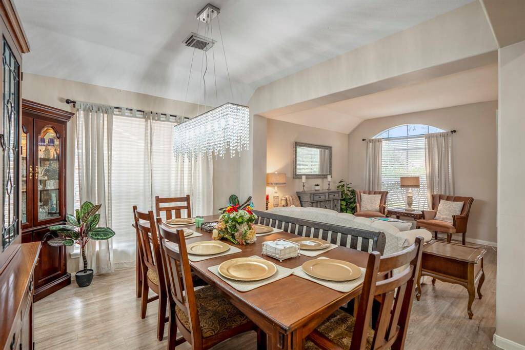 A view of the formal dining area with the inviting formal living area beyond, showcasing an open and airy space perfect for entertaining and creating lasting memories.