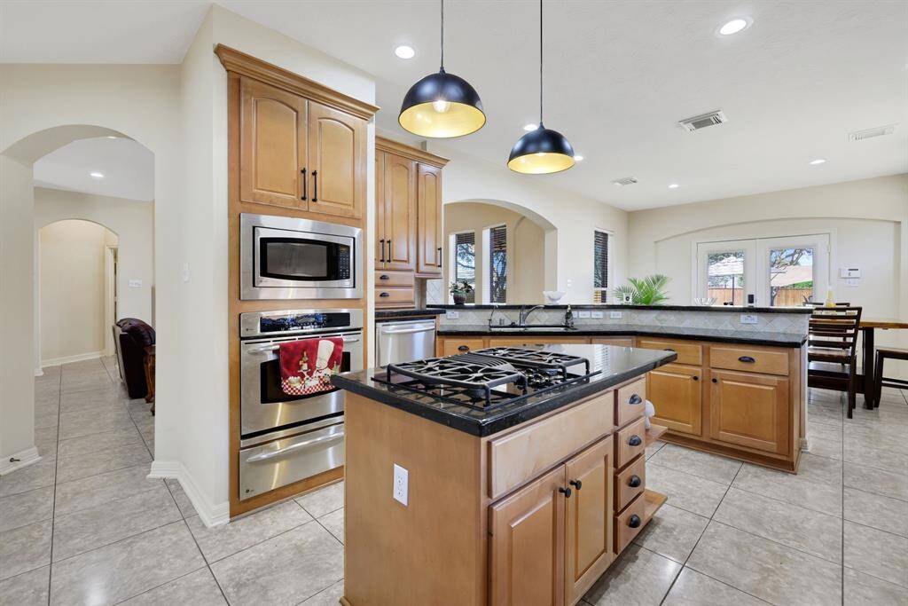 Stainless steel appliances, black hardware and the pendant lights bring a lot of character to this kitchen. Also, the windows provide a lot of natural light