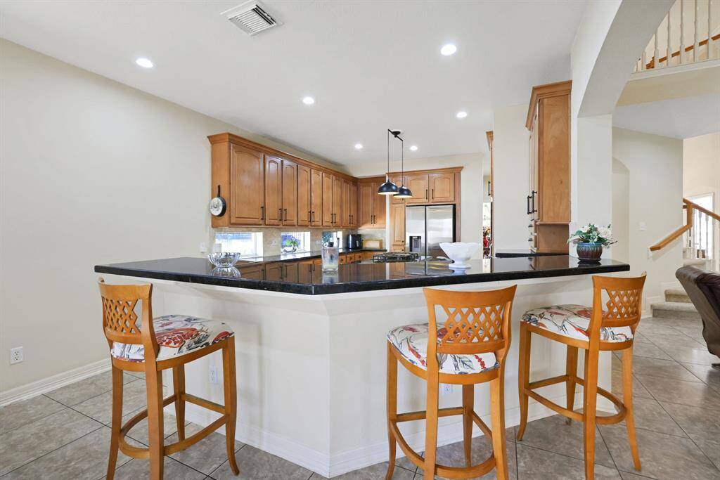 Breakfast area is spacious and right off the kitchen with doors that take you directly into the oasis backyard.