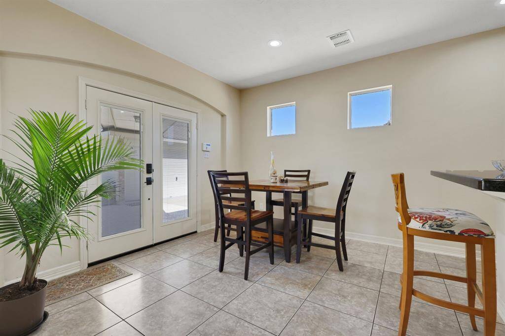 Family room features two story ceilings and tiled floors throughout.