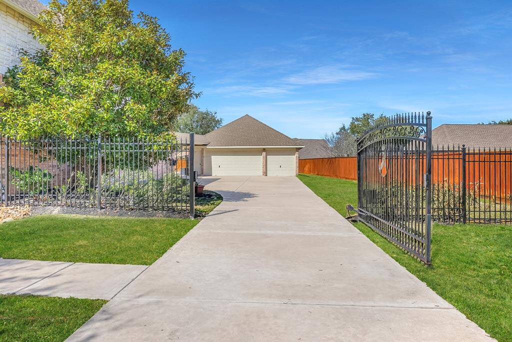Lovely 2 story home with a 6 car detached garage, gated driveway and sparkling pool and spa on a large over half acre lot