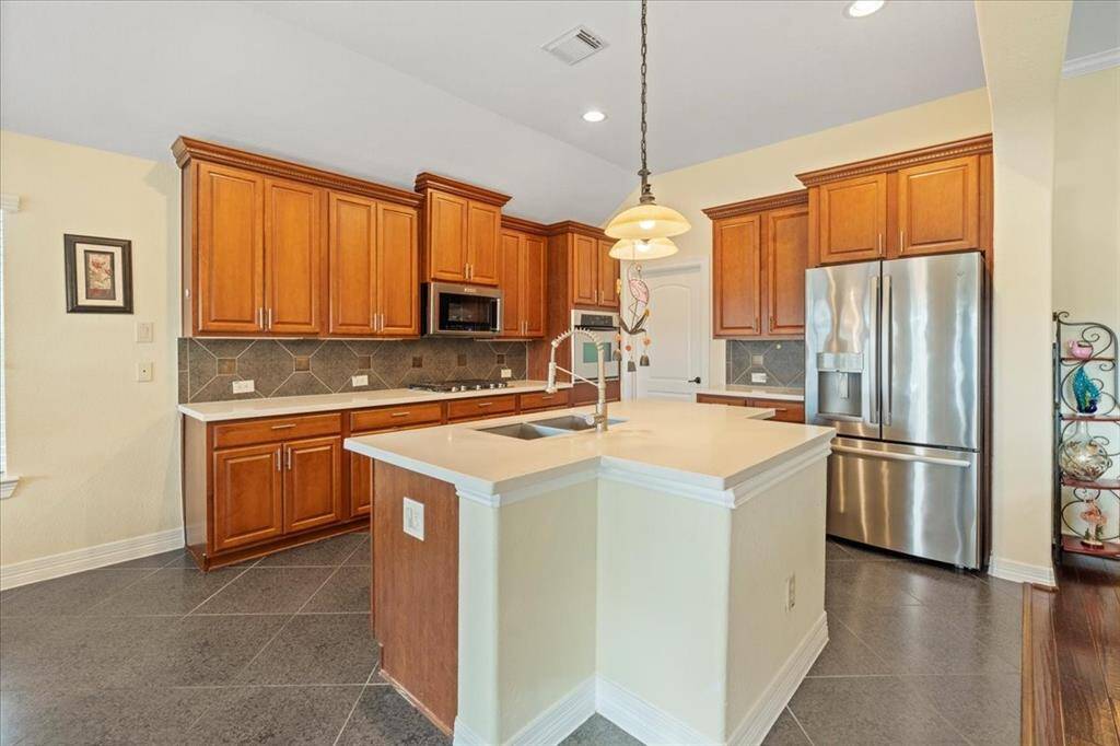 Another view of updated kitchen with door to pantry and laundry in corner