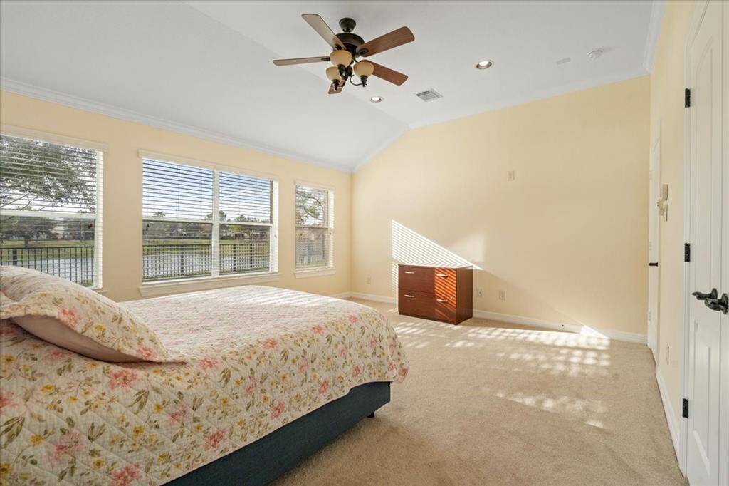 One more view of the primary bedroom with incredible lake views