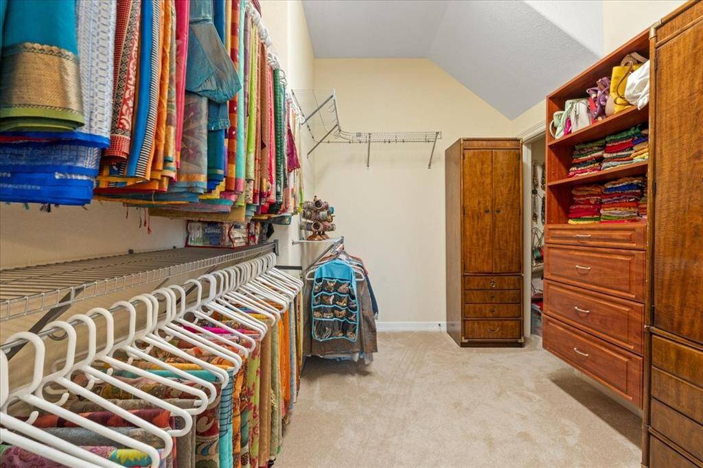Large primary closet with many storage possibilities