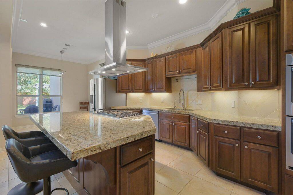 Thoughtful details like under-cabinet lighting, a stylish tile backsplash, and ample storage enhance the kitchen’s appeal. The open-concept design seamlessly connects to the living and dining areas, making it ideal for hosting gatherings or enjoying everyday meals in style.