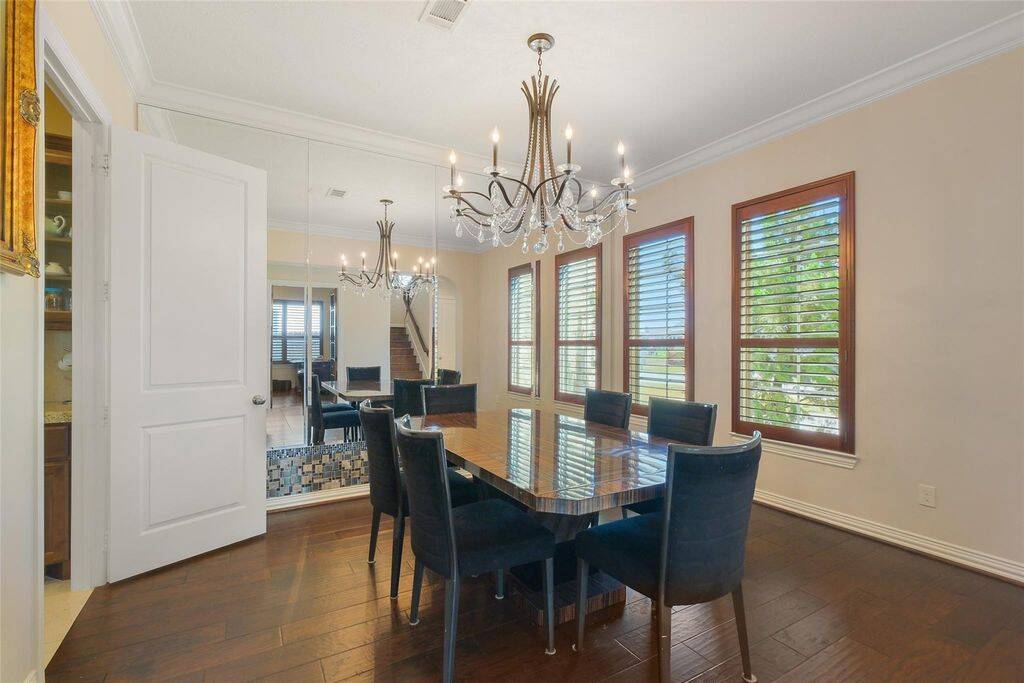 Perfectly designed for hosting and everyday luxury, this dining room is ready to make every meal a special occasion! Three large windows with custom wood shutters allow natural light to pour in, creating an inviting yet private dining experience. The seamless flow from the butler’s pantry to this beautiful space ensures effortless entertaining.