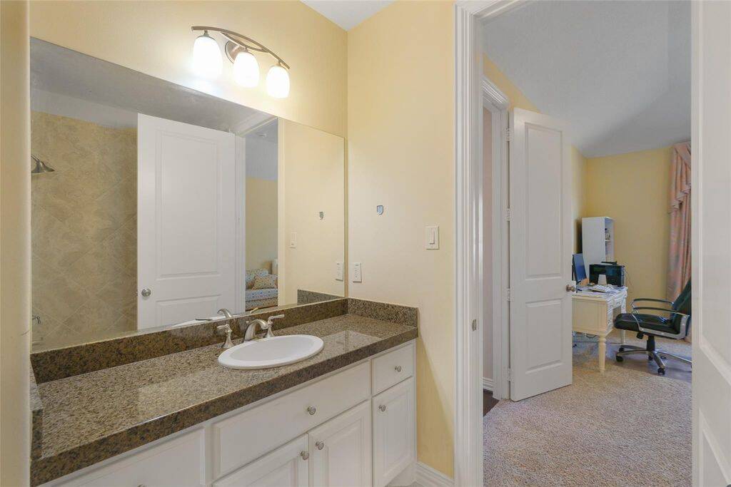 Conveniently connecting two bedrooms, this well-designed Jack-and-Jill bathroom offers both style and functionality. The granite countertop with a single undermount sink provides a sleek and polished look, while the modern lighting above the mirror enhances brightness and elegance.Designed for shared convenience, this bathroom ensures privacy while maintaining a spacious and airy feel. With high-end finishes and thoughtful design, it’s the perfect blend of practicality and sophistication.