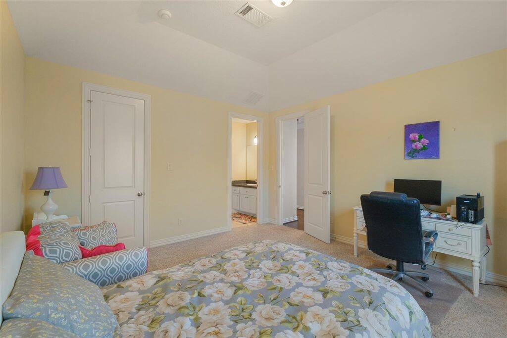 This inviting upstairs bedroom offers a warm and comfortable retreat, featuring soft yellow walls, plush carpeting, and a spacious layout. A large window brings in natural light, creating an airy and relaxing atmosphere.With direct Jack-and-Jill bathroom access, this room provides both privacy and convenience.