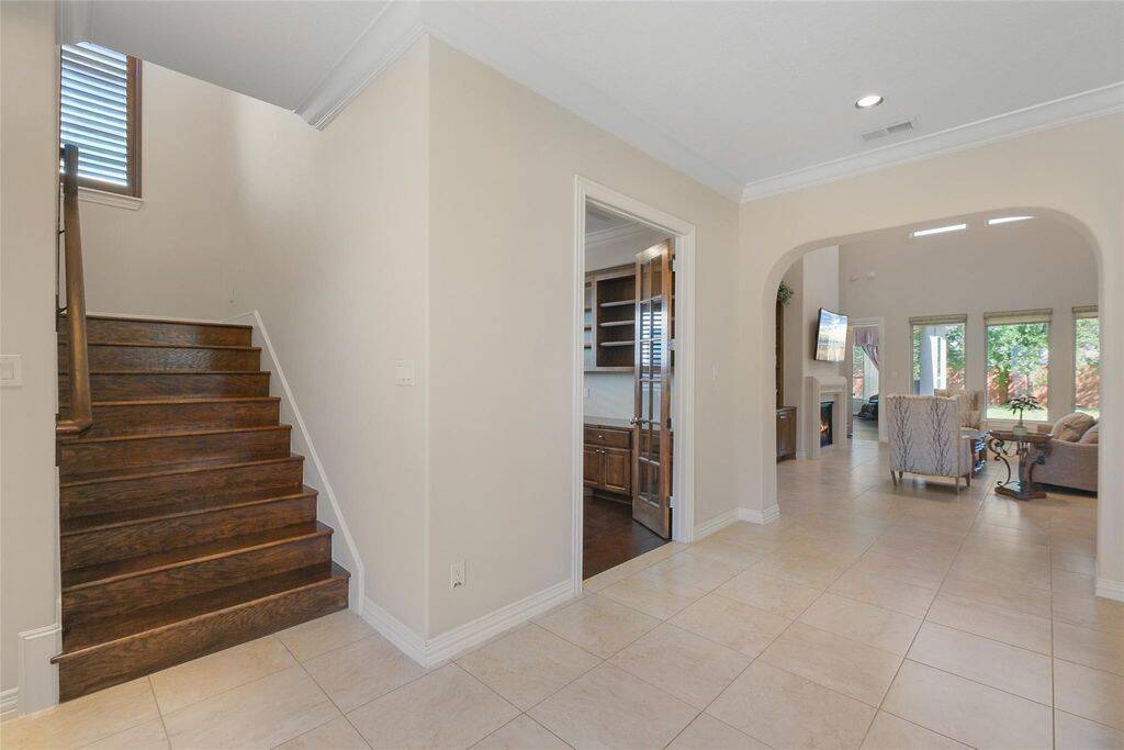 Natural light pours in, highlighting the seamless flow from the entryway to the heart of the home. Whether you're hosting guests or enjoying a quiet evening, this beautifully designed space offers a perfect balance of elegance and comfort.