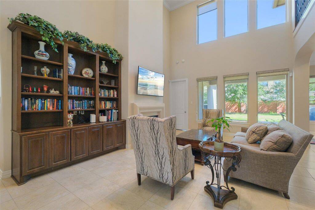 Experience the perfect blend of elegance and comfort in this breathtaking living room. Towering two-story ceilings and expansive windows flood the space with natural light, creating a bright and inviting atmosphere. The open-concept design allows for seamless indoor-outdoor living!