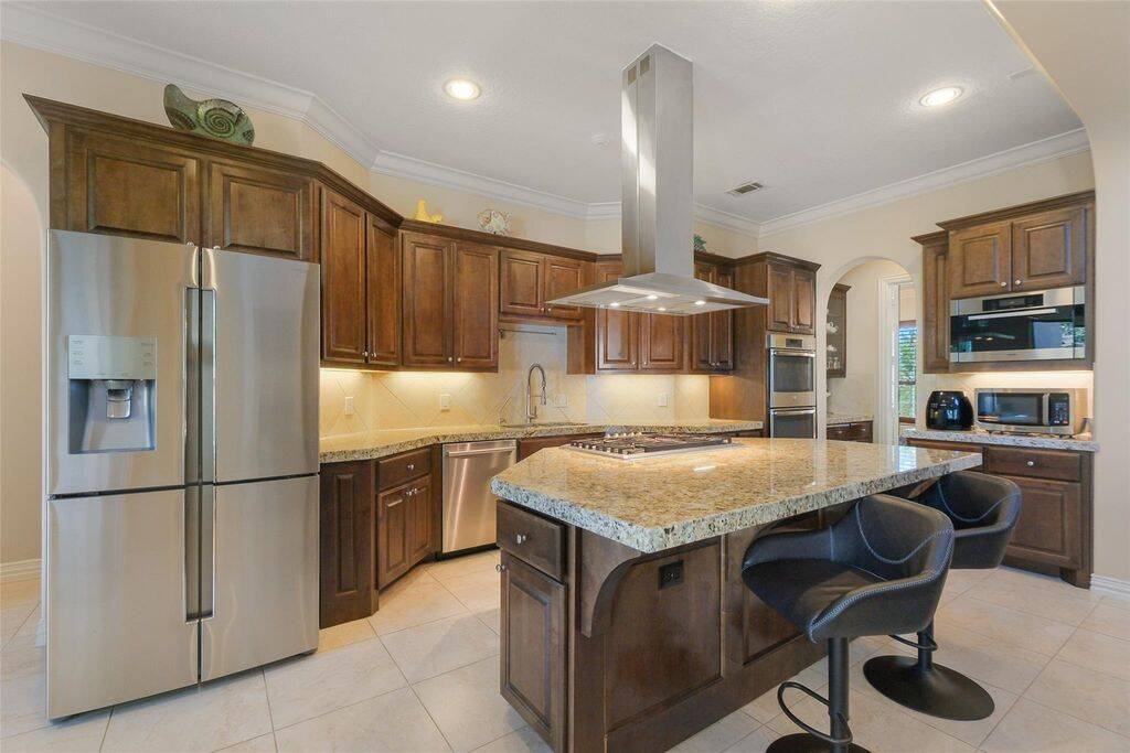 Step into a chef’s dream kitchen, where elegance meets practicality. Rich custom cabinetry, sleek granite countertops, and a large center island create the perfect space for culinary creativity and entertaining.