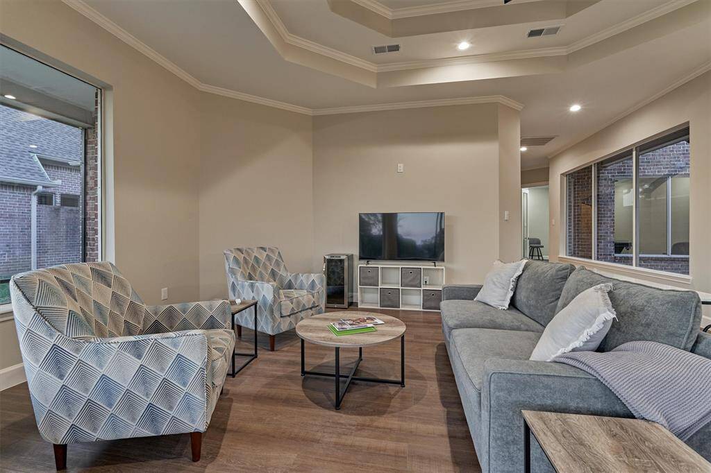 The family room boasts of a lighted recessed ceiling and updated tile flooring.