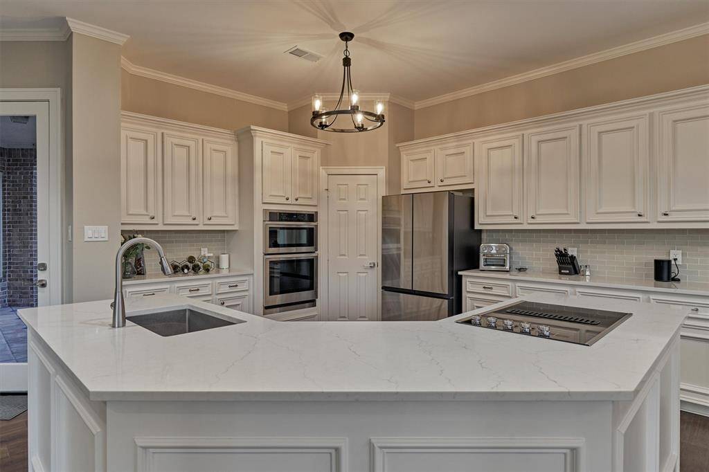 Sleek new Corian countertops adorn this updated modern kitchen. From this view you can see what a functionally well-planned out space this is!